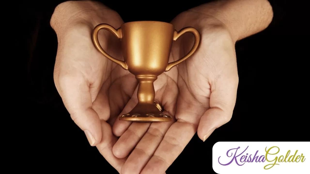 KG Hands holding Small trophy