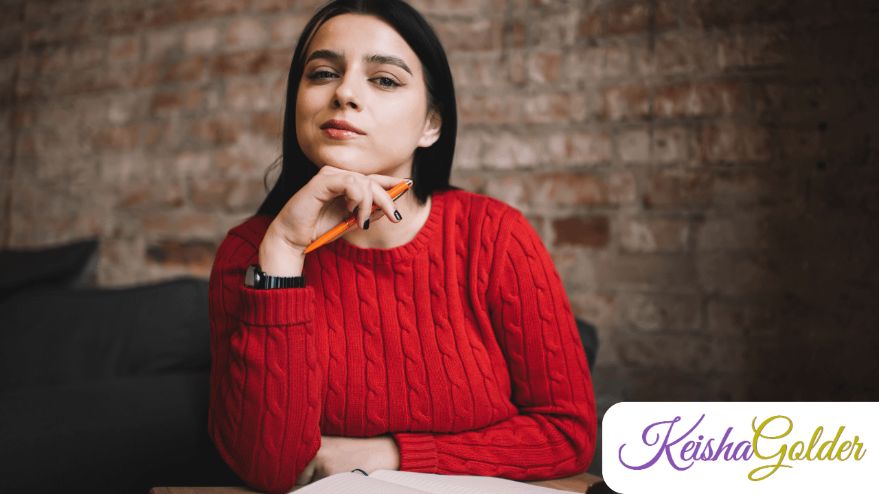 KG-KeishaGolder Intentional Living BPImage-1280x720 A woman in a red sweater looking off thinking